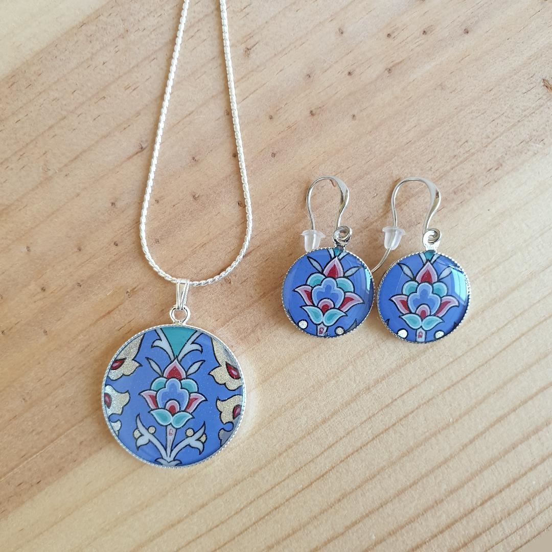 Boucles d'oreille pendantes enluminées fleur sur fond bleu